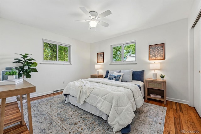 6088 Quail Ct, Arvada, CO 80004 - bedroom with multiple windows, wood finished floors, baseboards, and a ceiling fan