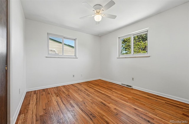 6088 Quail Ct, Arvada, CO 80004 - unfurnished room featuring healthy amount of natural light, baseboards, wood finished floors, and a ceiling fan