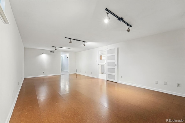 6088 Quail Ct, Arvada, CO 80004 - unfurnished room with track lighting, baseboards, built in shelves, and tile patterned floors