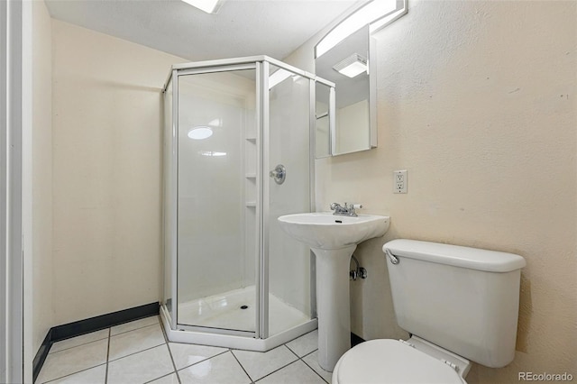 6088 Quail Ct, Arvada, CO 80004 - bathroom featuring tile patterned floors, toilet, and a shower stall