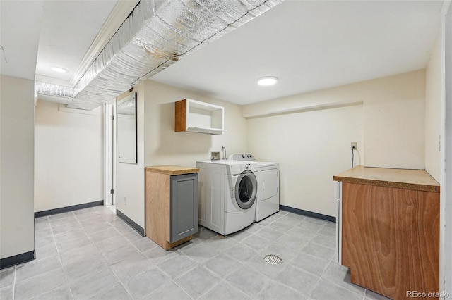 6088 Quail Ct, Arvada, CO 80004 - laundry area with cabinet space, washer and clothes dryer, and baseboards