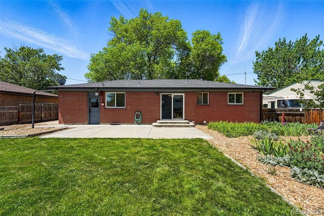 6088 Quail Ct, Arvada, CO 80004 - back of house with a patio area, brick siding, and entry steps