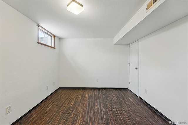 6088 Quail Ct, Arvada, CO 80004 - below grade area with dark wood-style flooring and baseboards