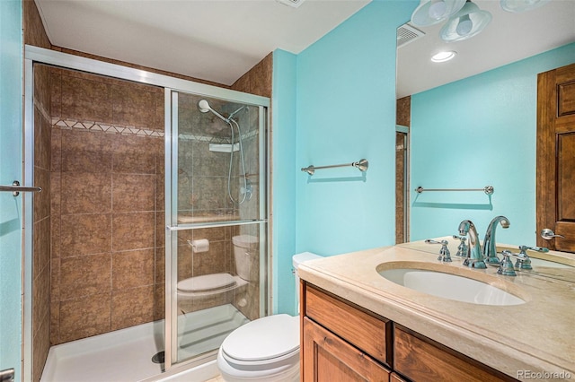 full bath featuring vanity, toilet, visible vents, and a stall shower