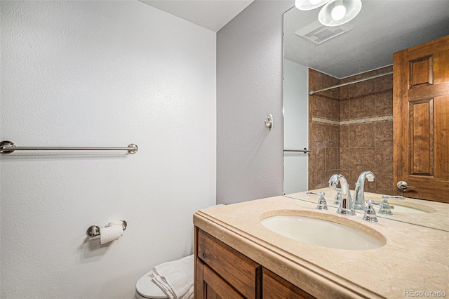 full bath with visible vents, toilet, walk in shower, and vanity