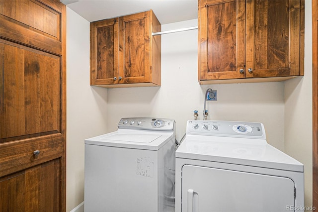 laundry area featuring cabinet space and independent washer and dryer