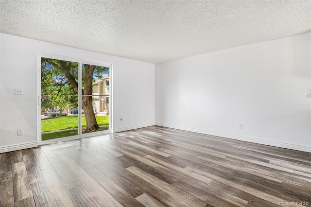 1534 S Ouray Cir Unit B, Aurora, CO 80017 - empty room featuring wood finished floors, a textured ceiling, and baseboards