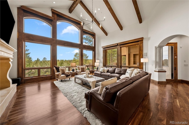 662 Yankakee Dr, Castle Rock, CO 80108 - living area with high vaulted ceiling, beamed ceiling, arched walkways, dark wood-type flooring, and an inviting chandelier