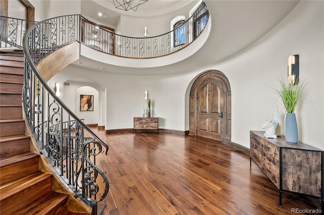 662 Yankakee Dr, Castle Rock, CO 80108 - foyer featuring arched walkways, baseboards, and wood finished floors