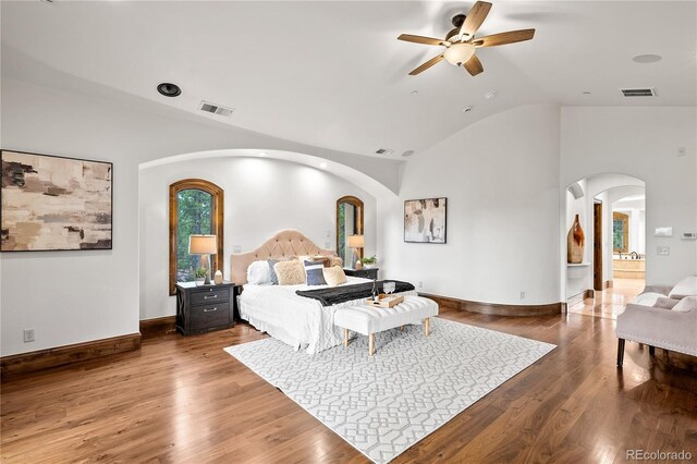 662 Yankakee Dr, Castle Rock, CO 80108 - bedroom with arched walkways, lofted ceiling, visible vents, and wood finished floors