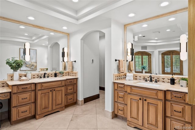 662 Yankakee Dr, Castle Rock, CO 80108 - full bathroom with a raised ceiling, a sink, tasteful backsplash, and two vanities