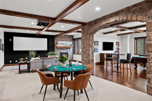662 Yankakee Dr, Castle Rock, CO 80108 - dining area with beamed ceiling, ornate columns, a fireplace, wood finished floors, and arched walkways