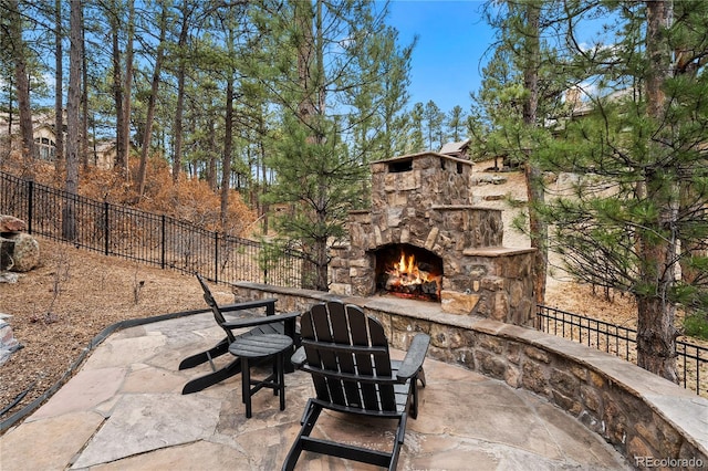 662 Yankakee Dr, Castle Rock, CO 80108 - view of patio / terrace with an outdoor stone fireplace and fence