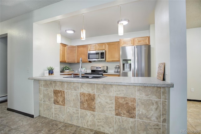 kitchen featuring decorative light fixtures, a peninsula, stainless steel appliances, light countertops, and a sink