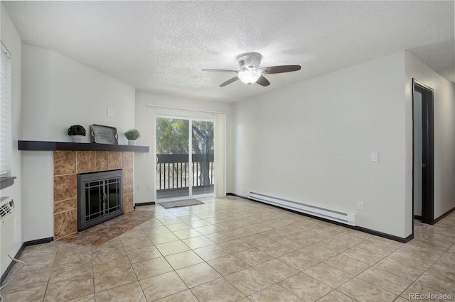 unfurnished living room with baseboards, a baseboard heating unit, a textured ceiling, and a tile fireplace