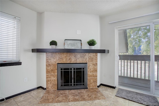 room details featuring a fireplace, baseboards, and a textured ceiling