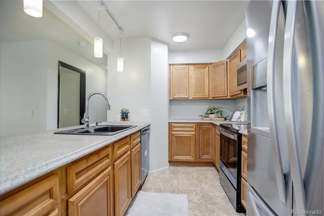 kitchen with a sink, light countertops, appliances with stainless steel finishes, brown cabinets, and decorative light fixtures