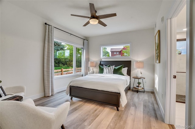 1308 Snowberry Ln Unit 303, Louisville, CO 80027 - bedroom featuring baseboards, light wood-style flooring, and ceiling fan