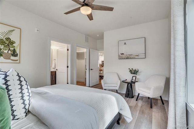 1308 Snowberry Ln Unit 303, Louisville, CO 80027 - bedroom featuring light wood-type flooring, a walk in closet, ensuite bath, and a ceiling fan