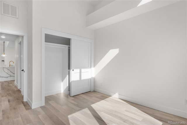 1308 Snowberry Ln Unit 303, Louisville, CO 80027 - unfurnished bedroom with light wood-type flooring, a closet, and baseboards