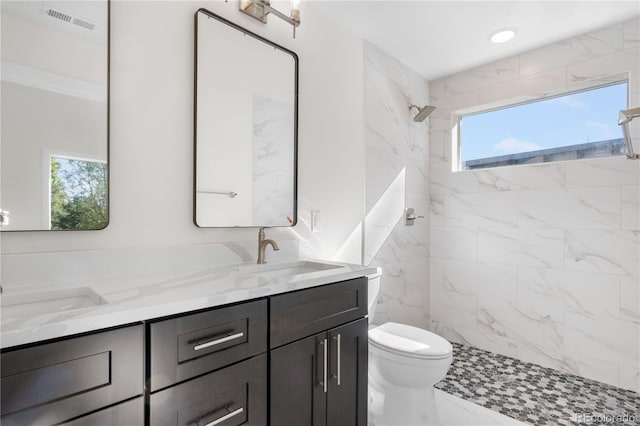 1308 Snowberry Ln Unit 303, Louisville, CO 80027 - full bath featuring double vanity, tiled shower, toilet, and marble finish floors