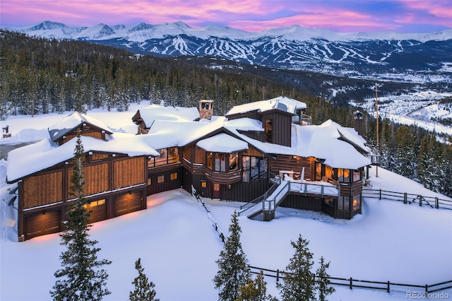 snowy aerial view featuring a mountain view