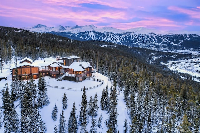 snowy aerial view with a mountain view