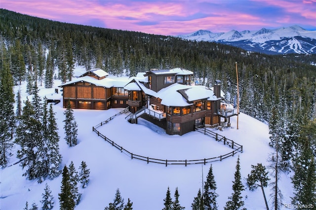 snowy aerial view featuring a mountain view