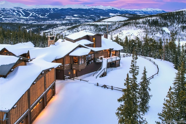 snowy aerial view with a mountain view