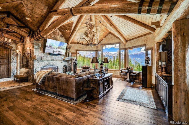 living room with a stone fireplace, beamed ceiling, dark hardwood / wood-style flooring, wood ceiling, and an inviting chandelier