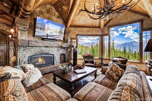 living room with hardwood / wood-style flooring, wood ceiling, high vaulted ceiling, and an outdoor stone fireplace