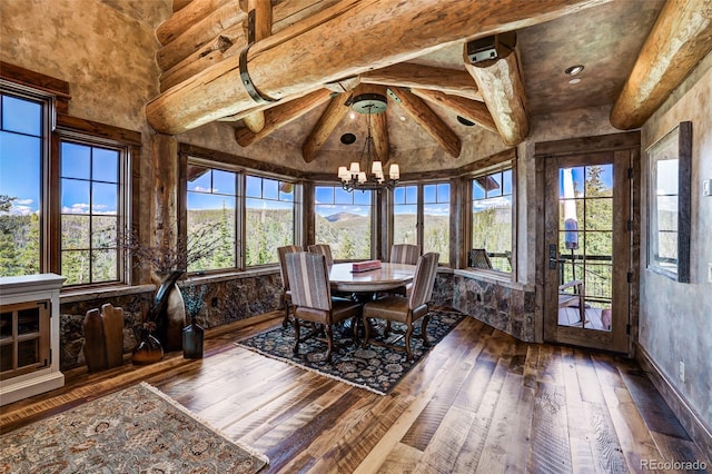 unfurnished sunroom featuring a chandelier and a mountain view