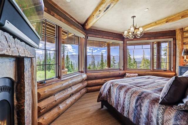 bedroom featuring beamed ceiling, a notable chandelier, and rustic walls