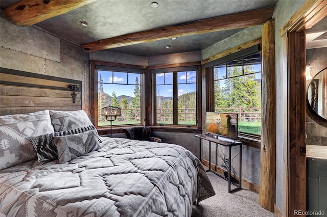 carpeted bedroom featuring beam ceiling