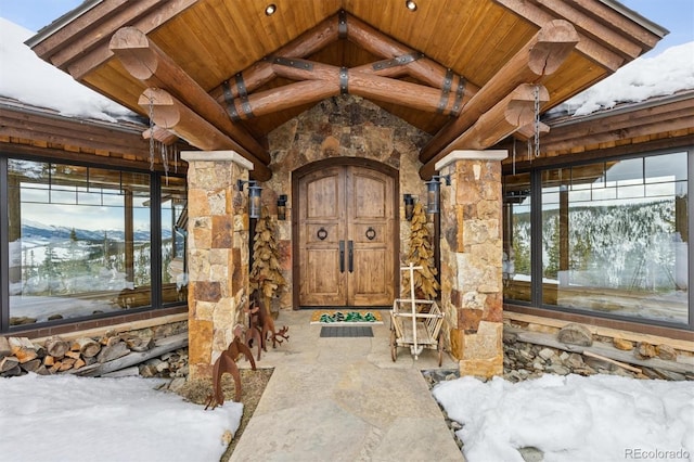 view of exterior entry featuring stone siding