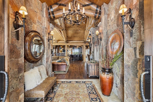 foyer featuring wooden ceiling, a notable chandelier, and high vaulted ceiling