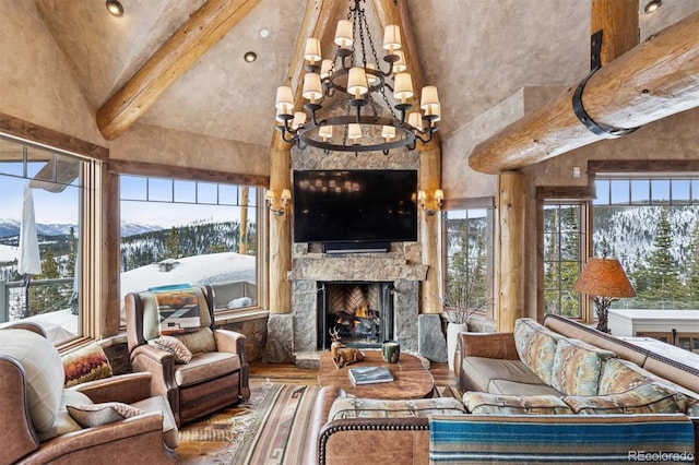 living area featuring wood finished floors, beamed ceiling, a fireplace, and high vaulted ceiling