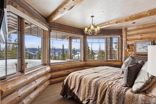 bedroom featuring beam ceiling, log walls, and a chandelier