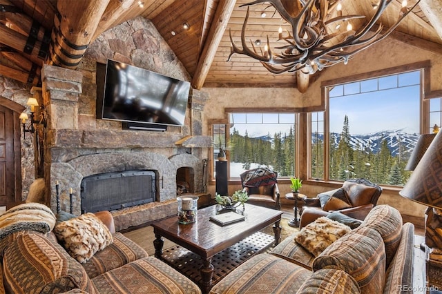 living area featuring wood finished floors, high vaulted ceiling, a fireplace, wood ceiling, and a chandelier