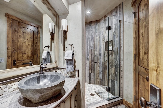 bathroom with a stall shower and vanity