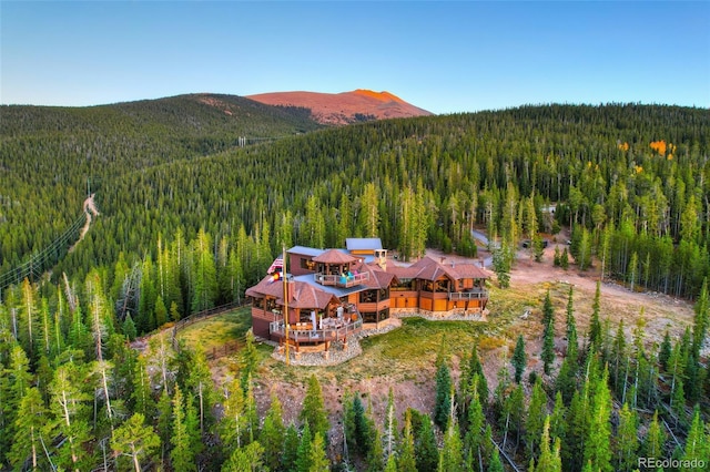 aerial view featuring a mountain view and a wooded view