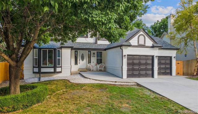 11260 W Fremont Ave, Littleton, CO 80127 - view of front of house with an attached garage, brick siding, concrete driveway, and a shingled roof
