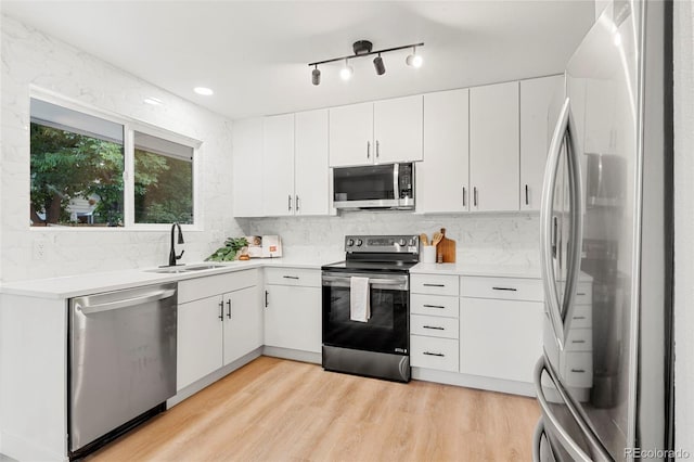 11260 W Fremont Ave, Littleton, CO 80127 - kitchen featuring stainless steel appliances, light countertops, and decorative backsplash