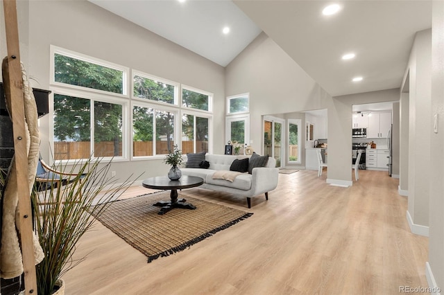 11260 W Fremont Ave, Littleton, CO 80127 - living area with high vaulted ceiling, light wood-type flooring, and recessed lighting