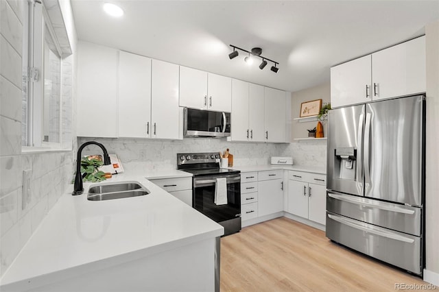 11260 W Fremont Ave, Littleton, CO 80127 - kitchen featuring appliances with stainless steel finishes, backsplash, light countertops, white cabinets, and recessed lighting