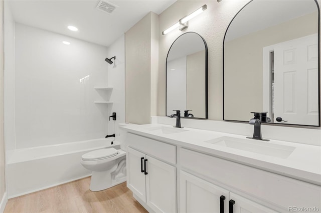 11260 W Fremont Ave, Littleton, CO 80127 - full bathroom featuring wood finished floors, double vanity, and shower / washtub combination