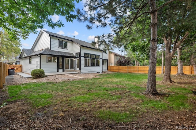 11260 W Fremont Ave, Littleton, CO 80127 - rear view of property with a fenced backyard, roof with shingles, and a patio area