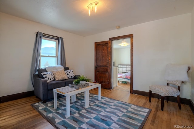 living room featuring baseboards and light wood finished floors