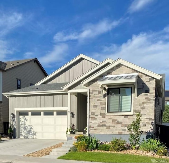 view of front of house featuring a garage, stone siding, board and batten siding, and concrete driveway