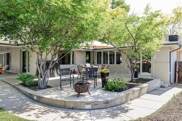 3901 S Dexter St, Cherry Hills Village, CO 80113 - back of house featuring an outdoor fire pit, a patio area, and stucco siding